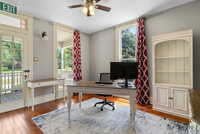 office featuring ceiling fan, a healthy amount of sunlight, and hardwood / wood-style flooring