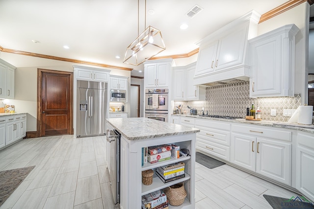 kitchen with white cabinetry, built in appliances, decorative light fixtures, a kitchen island, and beverage cooler