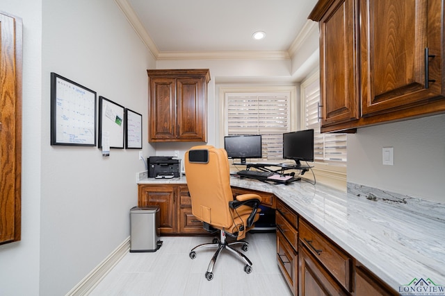 office space featuring ornamental molding and built in desk