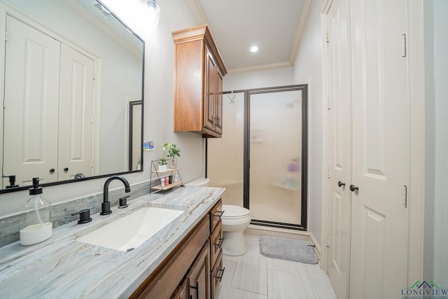 bathroom with vanity, an enclosed shower, ornamental molding, tile patterned floors, and toilet