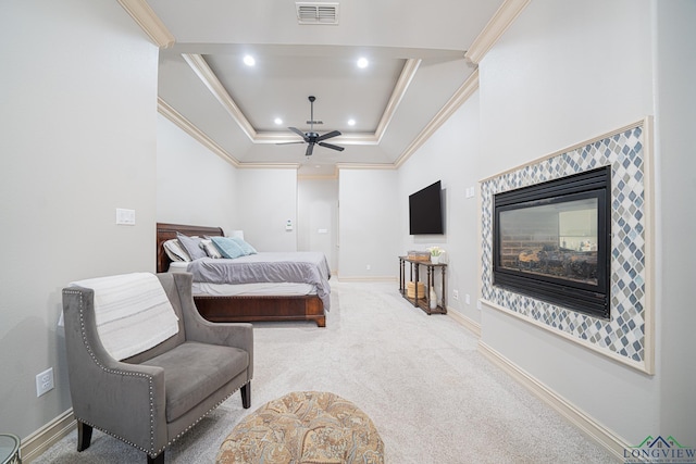 bedroom featuring a multi sided fireplace, ornamental molding, carpet flooring, and a raised ceiling