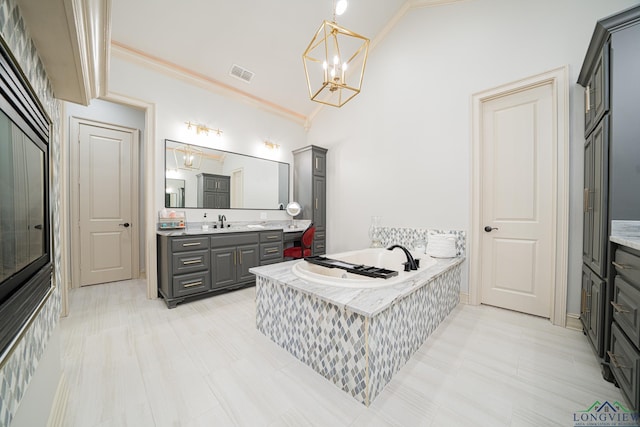 bathroom featuring an inviting chandelier, high vaulted ceiling, ornamental molding, vanity, and a relaxing tiled tub