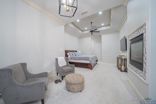 carpeted bedroom with ornamental molding, an inviting chandelier, and a tray ceiling