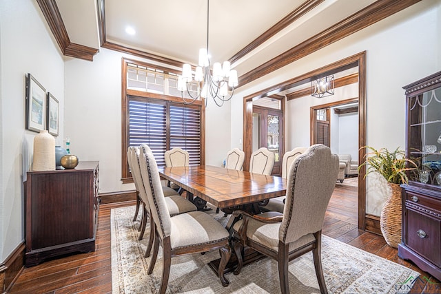 dining room with dark hardwood / wood-style flooring, crown molding, a raised ceiling, and a chandelier