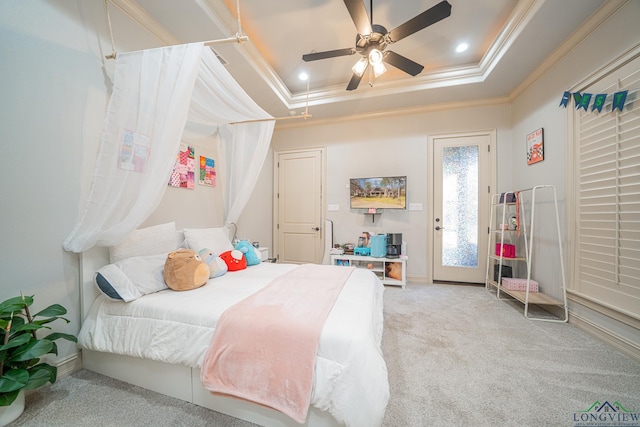 carpeted bedroom featuring access to exterior, crown molding, a raised ceiling, and ceiling fan