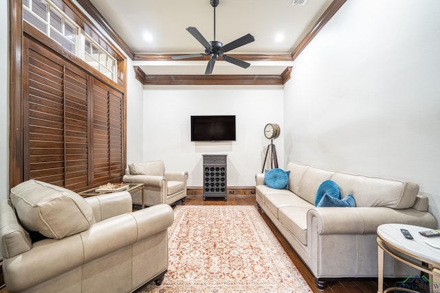 living room with hardwood / wood-style flooring, ornamental molding, and ceiling fan