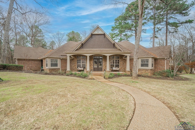 craftsman house with a porch and a front lawn