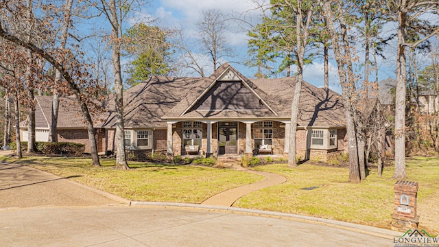 view of front facade featuring a front lawn and covered porch