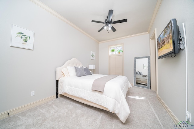 carpeted bedroom featuring crown molding and ceiling fan