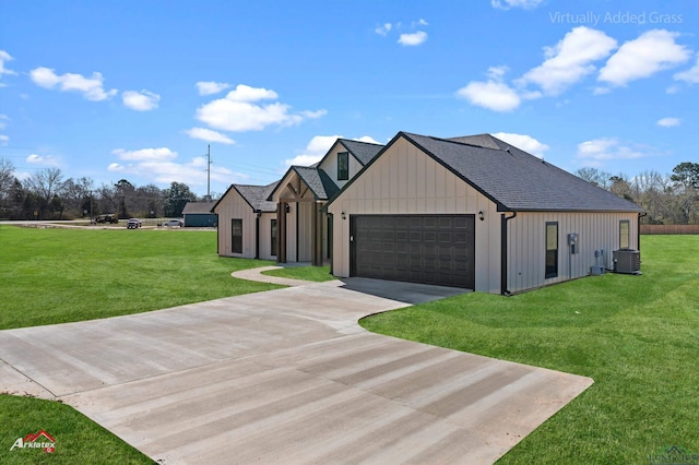 view of side of home featuring a yard, board and batten siding, concrete driveway, and roof with shingles