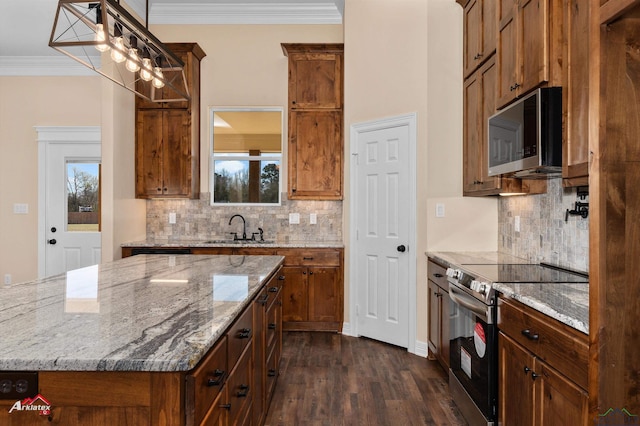 kitchen with a sink, crown molding, light stone counters, stainless steel appliances, and dark wood-style flooring