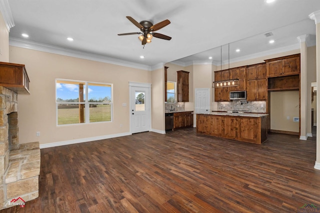 kitchen with dark wood-style floors, ceiling fan, decorative backsplash, a stone fireplace, and stainless steel appliances