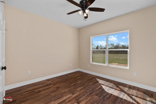 unfurnished room with dark wood-type flooring, baseboards, and ceiling fan