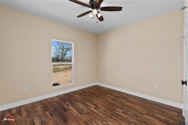 empty room with a ceiling fan, dark wood-type flooring, and baseboards