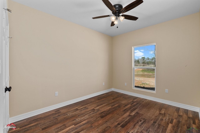 unfurnished room with dark wood-style floors, ceiling fan, and baseboards