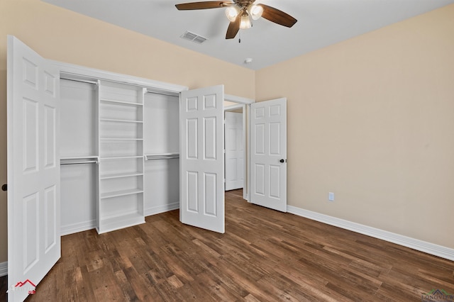 unfurnished bedroom with a ceiling fan, baseboards, visible vents, dark wood finished floors, and a closet