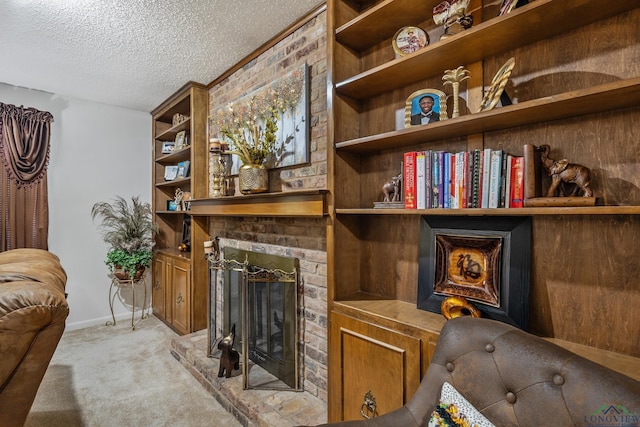 carpeted living room featuring a textured ceiling and a fireplace