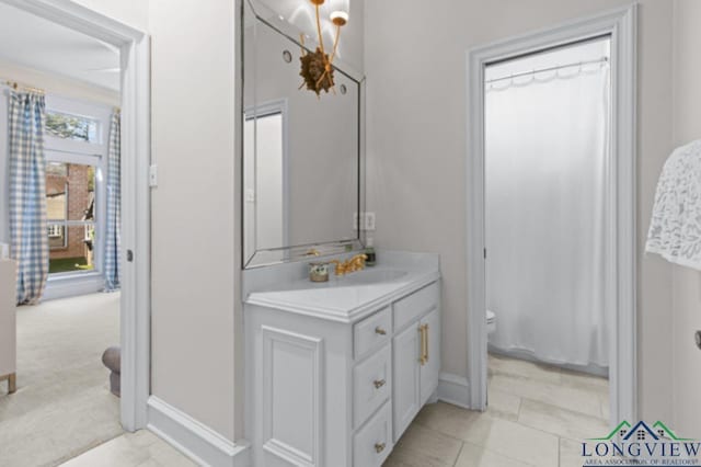 bathroom with tile patterned flooring, vanity, and toilet