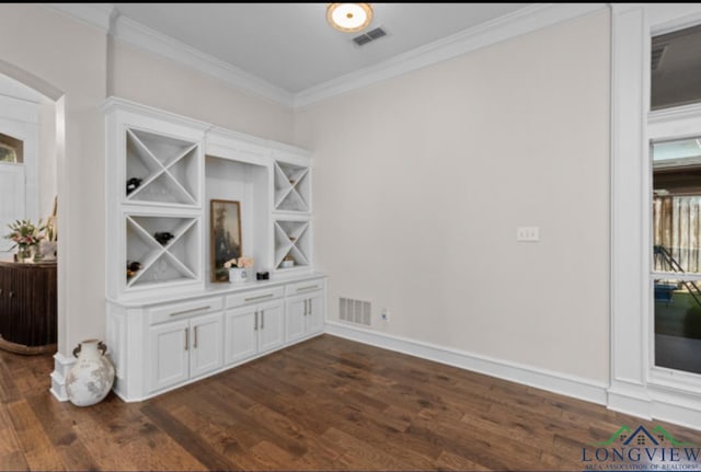 dining space with dark hardwood / wood-style flooring and ornamental molding