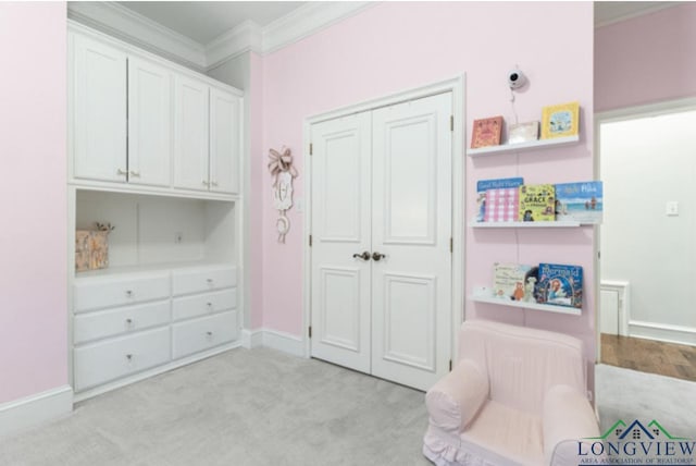 living area featuring light colored carpet and crown molding