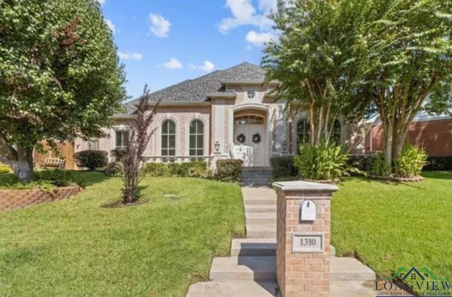 mediterranean / spanish-style house with a front lawn