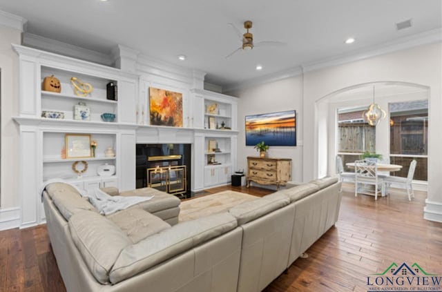 living room featuring ceiling fan, dark hardwood / wood-style flooring, and crown molding