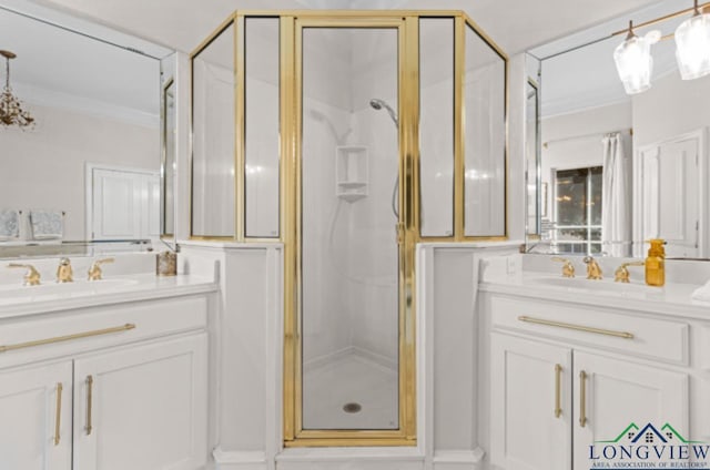 bathroom with vanity, an enclosed shower, and ornamental molding