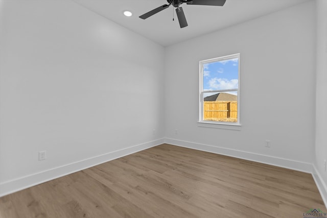 empty room with ceiling fan, recessed lighting, light wood-type flooring, and baseboards