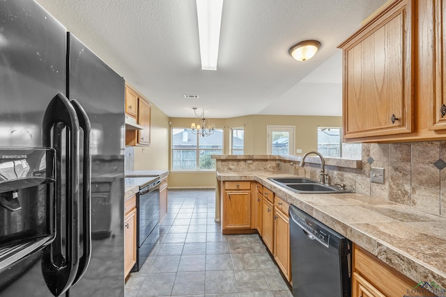 207 Willow Rd, Bullard, TX 75757 - kitchen with plenty of natural light, under cabinet range hood, a sink, black appliances, and backsplash