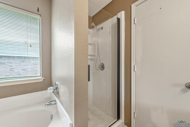 207 Willow Rd, Bullard, TX 75757 - bathroom featuring a stall shower, a textured wall, and a bath