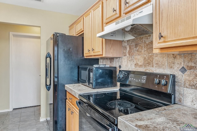 207 Willow Rd, Bullard, TX 75757 - kitchen featuring light tile patterned flooring, light brown cabinets, under cabinet range hood, black appliances, and backsplash