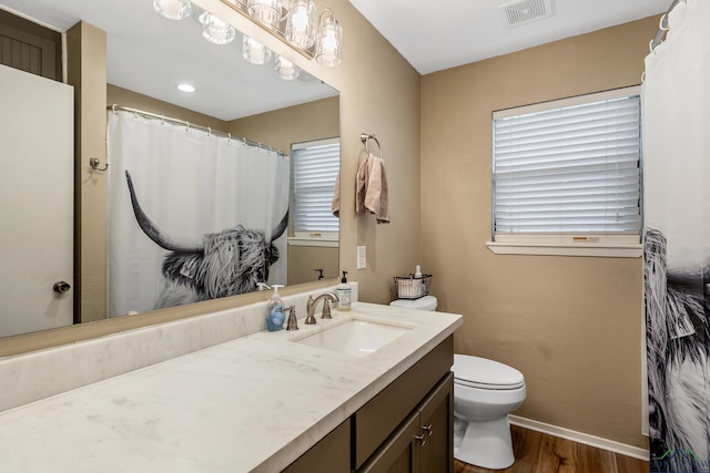 bathroom featuring hardwood / wood-style floors, vanity, and toilet