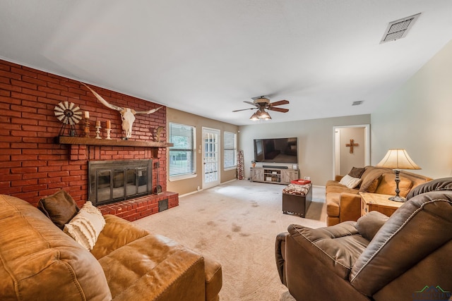 living room featuring carpet floors, a brick fireplace, and ceiling fan