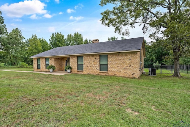 ranch-style house with central AC, a patio area, and a front lawn