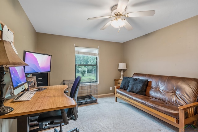 carpeted office space featuring ceiling fan