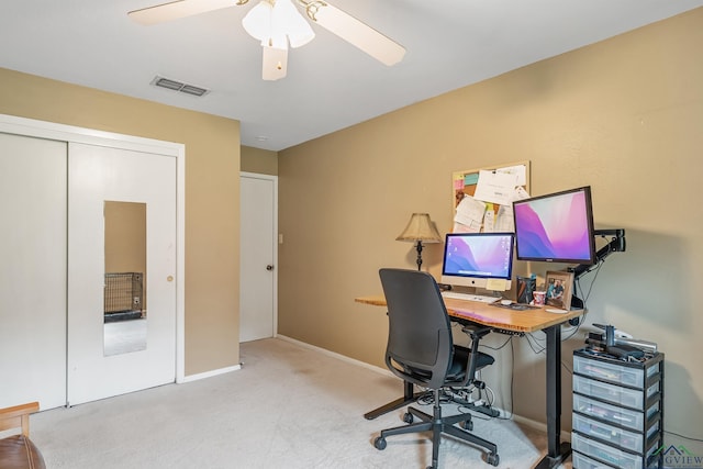 home office featuring ceiling fan and light carpet