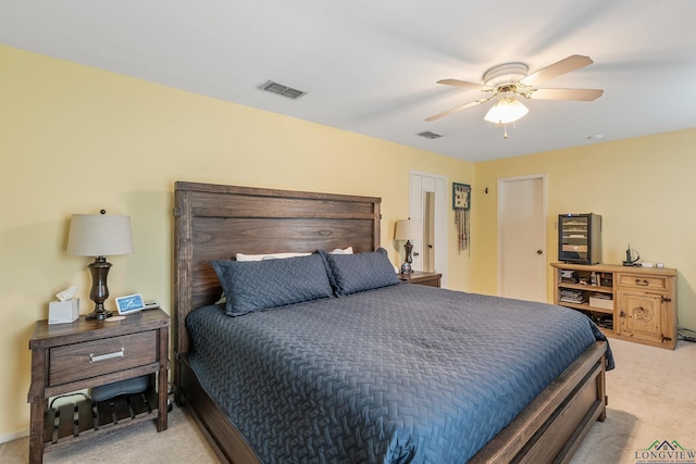 bedroom with ceiling fan and light colored carpet