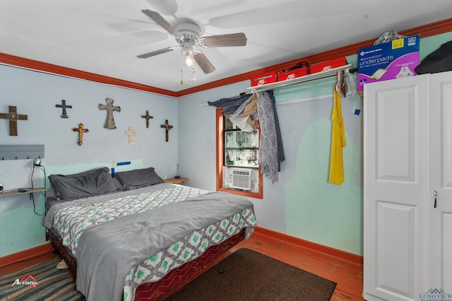 bedroom with ceiling fan, crown molding, cooling unit, and wood-type flooring