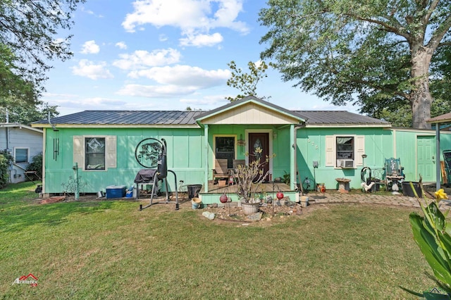 view of front of property with a front lawn and cooling unit