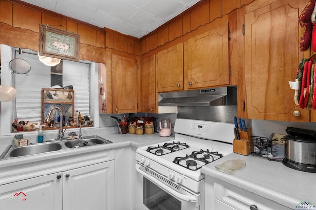 kitchen with white cabinetry, sink, and white range with gas cooktop