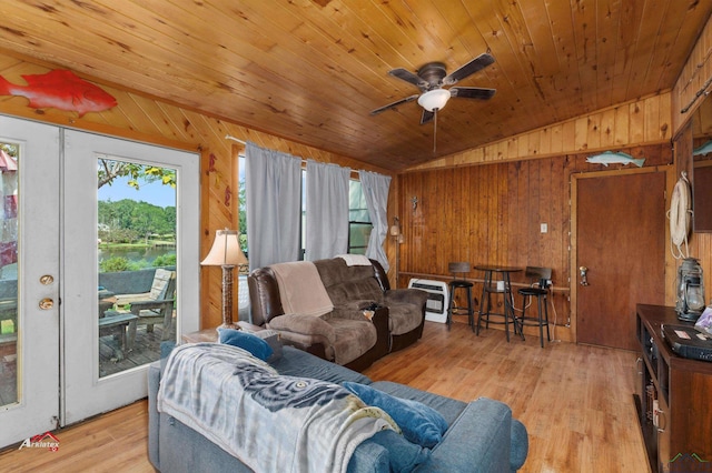 living room with wood ceiling, vaulted ceiling, ceiling fan, wooden walls, and light hardwood / wood-style flooring