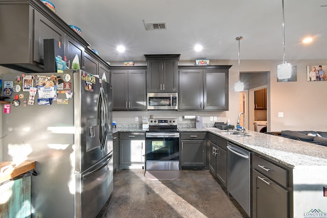 kitchen with sink, decorative light fixtures, light stone counters, kitchen peninsula, and stainless steel appliances