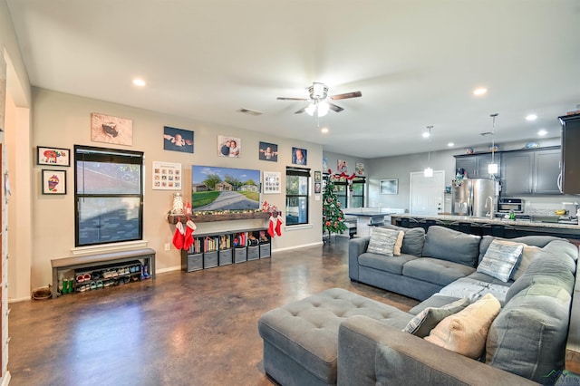 living room with a wealth of natural light and ceiling fan