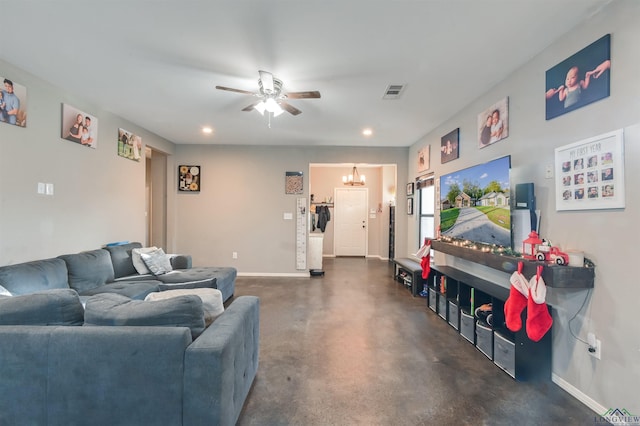 living room featuring ceiling fan with notable chandelier