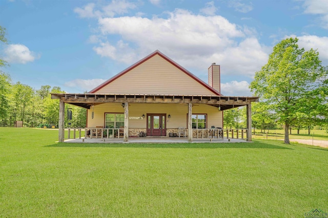 4754 Deer Rd, Gilmer, TX 75644 - rear view of property with a patio area, a chimney, and a yard