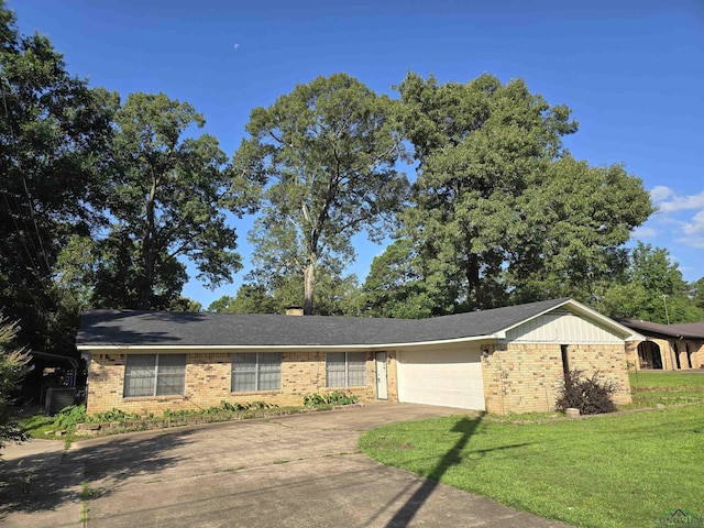 711 Wildwood Rd, Daingerfield, TX 75638 - ranch-style home with brick siding, concrete driveway, a garage, a front yard, and a chimney