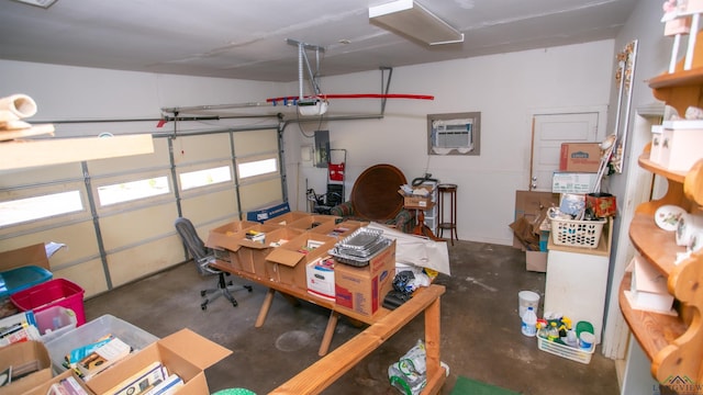 garage featuring a wall unit AC and a garage door opener