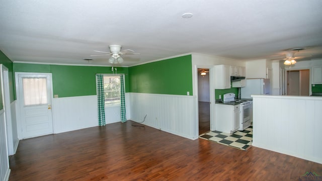 unfurnished living room featuring ceiling fan and dark hardwood / wood-style flooring