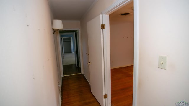 hall featuring dark hardwood / wood-style flooring and ornamental molding