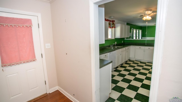 kitchen with ceiling fan, sink, white cabinets, and white dishwasher